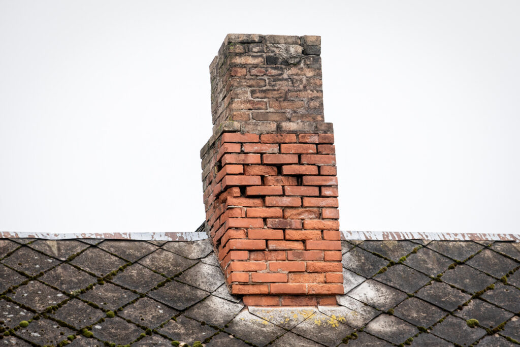 Old brick chimney with failing and missing mortar.